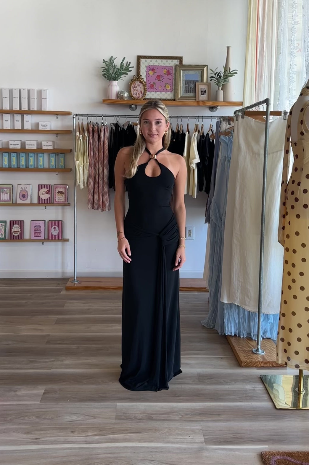 Black, maxi dress with halter neckline, front cutout, fitted bodice, and draped scarf fabric
