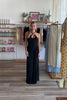 Black, maxi dress with halter neckline, front cutout, fitted bodice, and draped scarf fabric