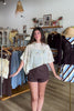 Cream, floral sequin poncho with boat neckline, asymmetrical hem, and sheer fabric | Pixelated Boutique, Virginia Beach Clothing Stores, Clothing Stores in Virginia Beach, Virginia Beach Boutique, 757 Boutique, Beach Fashion, Vacation Style, Coastal Cowgirl Aesthetic
