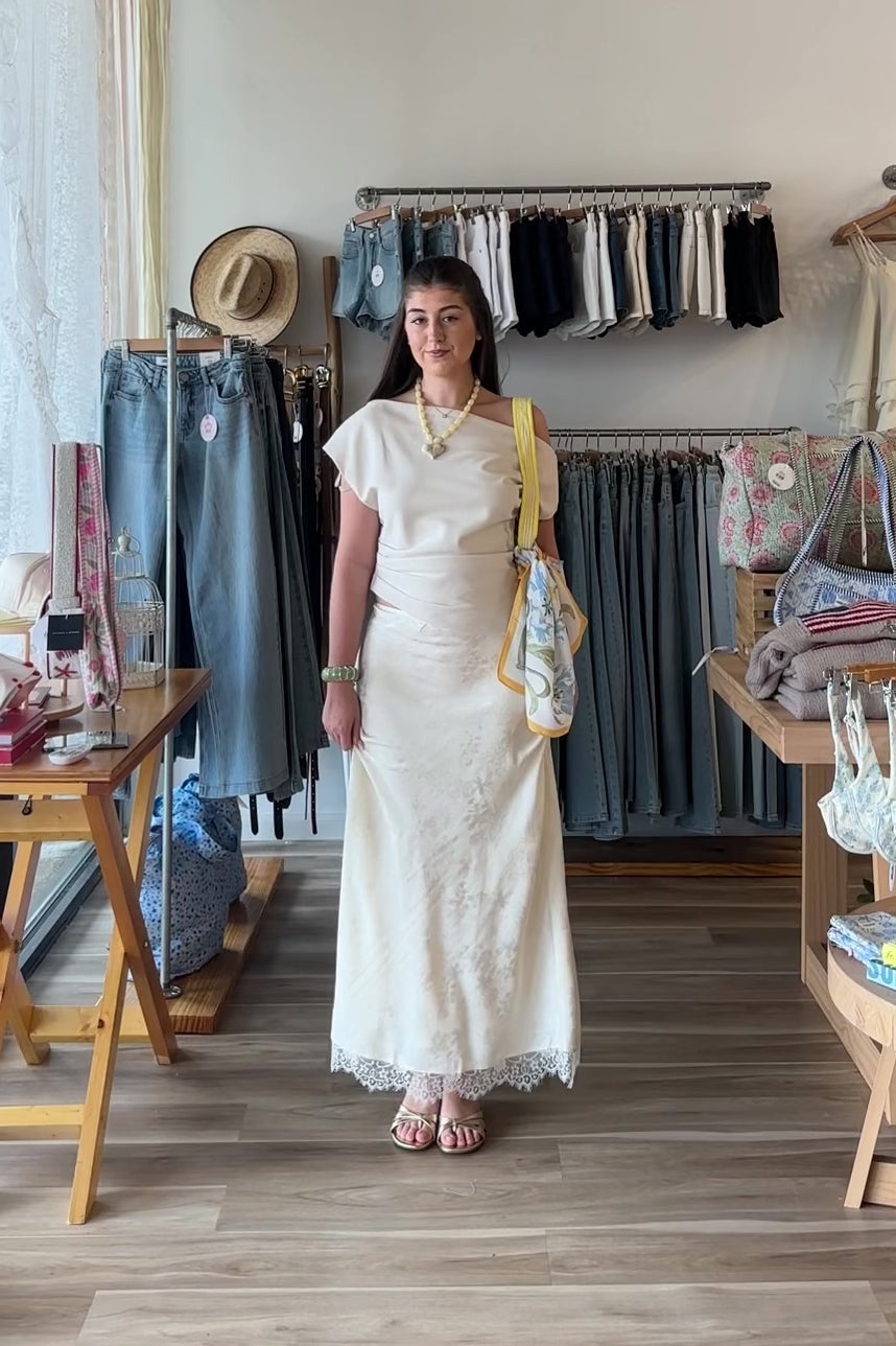 Cream, satin jacquard midi skirt with bias cut, lace trim, front bow, and side zipper, lace midi skirt, eyelet lace maxi skirt, summer maxi skirt, lace midi skirt for summer, bridal outfits, graduation dress, lace skirt for summer, beach fashion, coastal cowgirl aesthetic, beach girl outfits