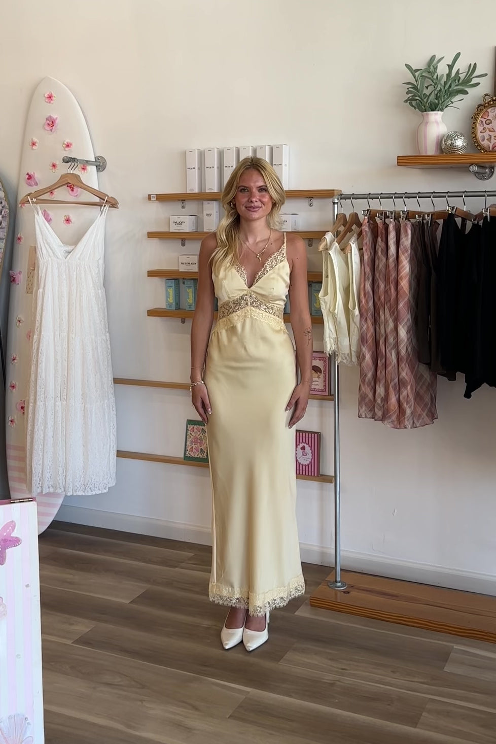 Yellow, satin maxi dress with V neckline, lace trim, open back, and adjustable cross straps