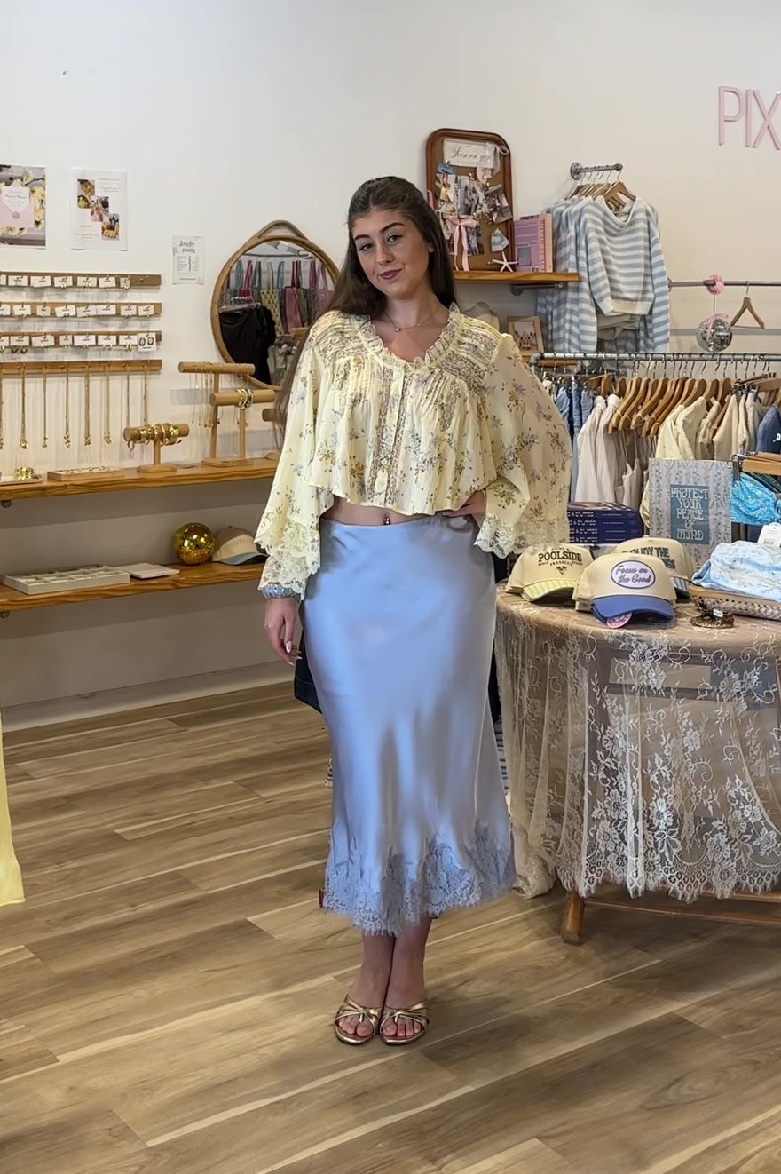 Blue, satin midi skirt with bias cut, lace hem, and side zipper, coastal cowgirl outfits, coastal aesthetic clothing, clean girl outfits, lace trim satin slip skirt, satin midi skirt, baby blue skirt for summer, low rise satin skirt, lace skirt for summer, happy hour outfit, summer satin skirt