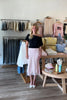 Pink, polka dot satin midi skirt with bias cut, lined interior lace hem, and side zipper