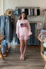 Cream, satin shorts with mid rise, lace hem, and elastic waist, Satin lace trim shorts for summer, women’s satin shorts, silky lace shorts, coquette satin shorts with lace trim, soft girl loungewear, romantic lace hem satin shorts for summer, summer aesthetic fashion, vacation style, vacation outfits, beach fashion, trendy summer shorts