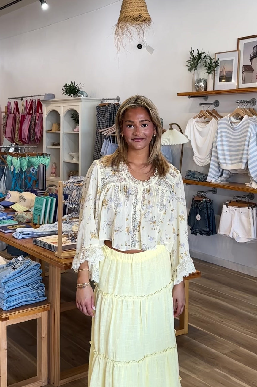 Yellow, floral blouse with lace trim and panelling, quarter sleeves, button down, and cropped length, boho blouse, summer aesthetic, brunch outfit, vacation style, vacation outfits, beach boutique, beach fashion, beach outfits, women’s boutique clothing, boutique clothing for women, coastal cowgirl outfits, coastal aesthetic clothing