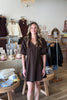 Brown, mini dress with V neckline, puff sleeves, pleated front, and A-line fit | Pixelated Boutique, Boutique Shopping in Virginia Beach, Women’s Boutique, Fall Fashion, Fall Dresses, Fall Shopping, Trendy Fall Outfits, Women’s Fall Clothing, Casual Fall Outfits