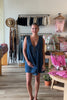 Blue, denim romper with V neckline, front tie, pockets, and pleated back, women’s boutique clothing, boutique clothing for women, coastal cowgirl outfits, coastal aesthetic clothing, business casual, concert outfit, 2000s fashion, western outfits