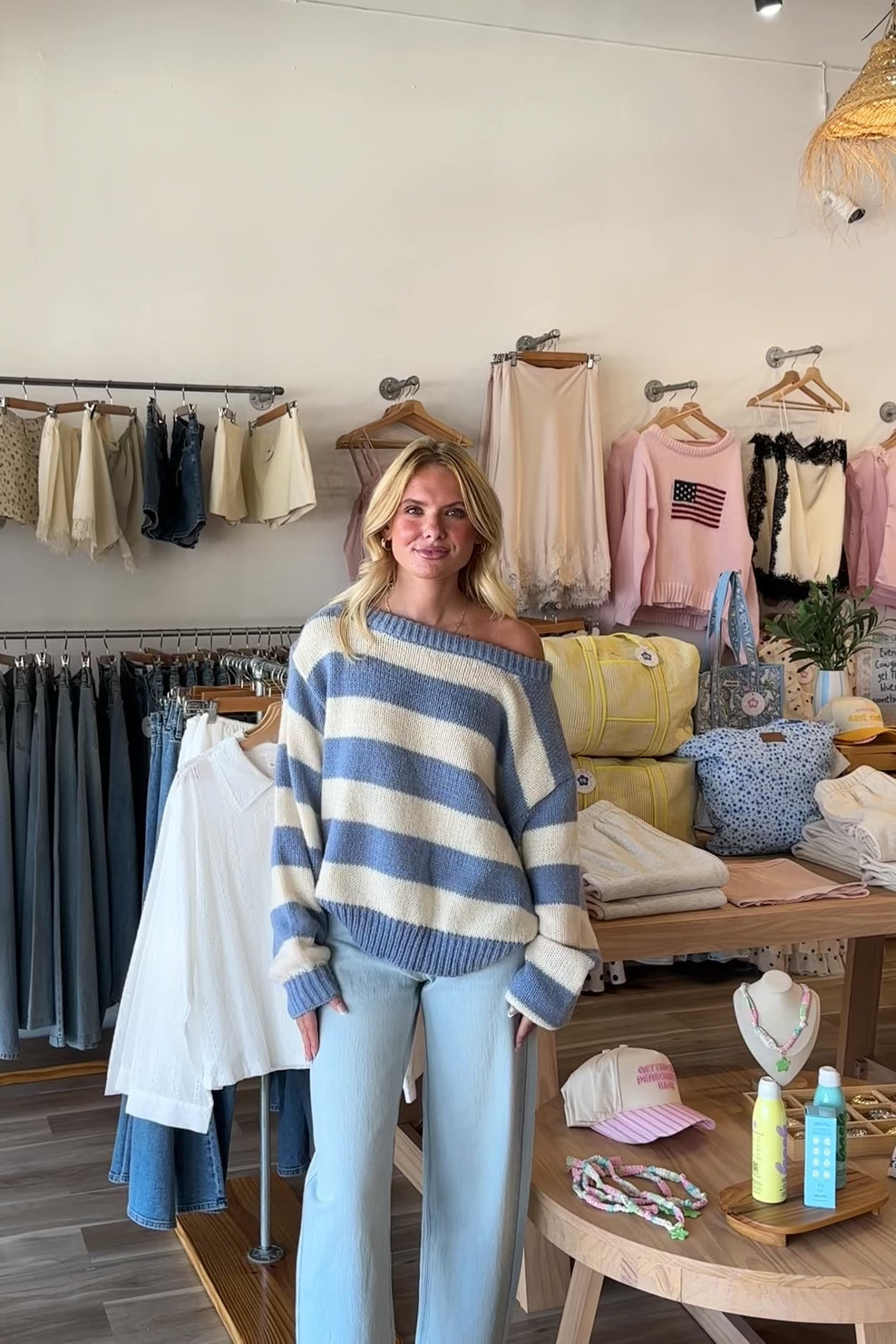 Blue, striped knit sweater with off-shoulder boat neckline and ribbed hem