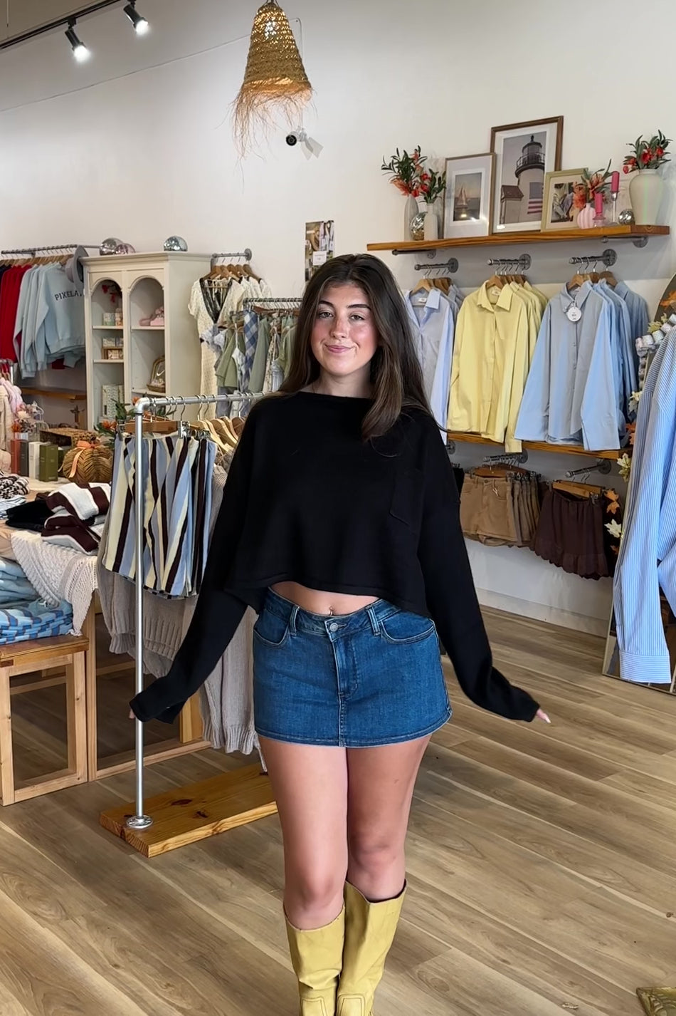 Black, knit sweater with drop shoulder, front pocket, slit sleeves, and cropped length
